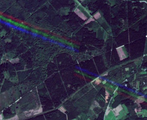 Image showing aircraft trails as parallel red, green and blue lines.